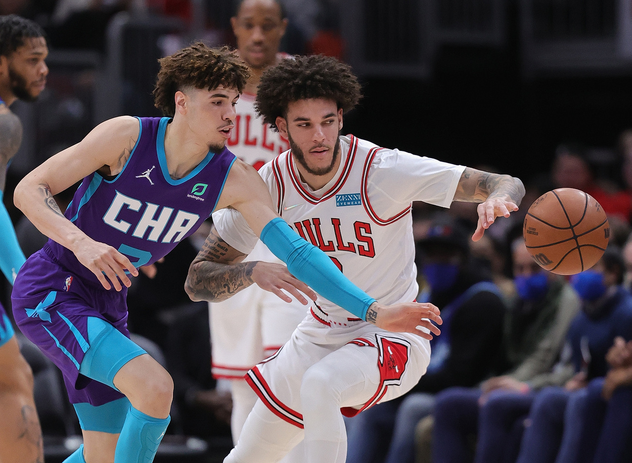 Guards and brothers LaMelo Ball and Lonzo Ball fight for the ball.