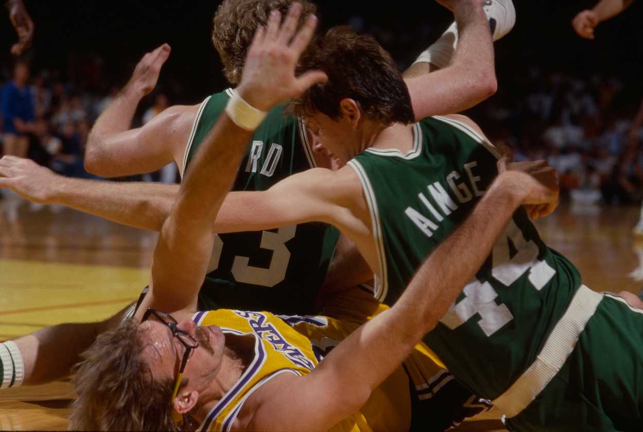 Los Angeles Lakers Kurt Rambis and Boston Celtics Danny Ainge and Larry Bird all end up on floor during 1985 NBA Finals action.