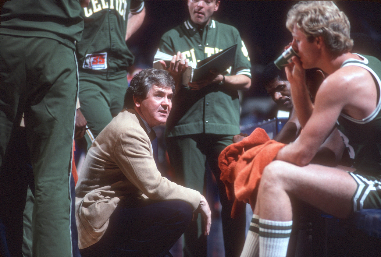 Head coach Bill Fitch of the Boston Celtics talks with his players.