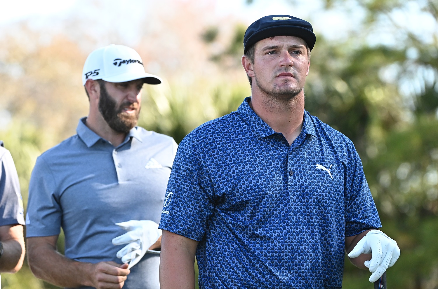 Dustin Johnson and Bryson DeChambeau walk down a fairway during the second round of The Players Championship at TPC Sawgrass on March 12, 2021, in Ponte Vedra Beach, Florida.