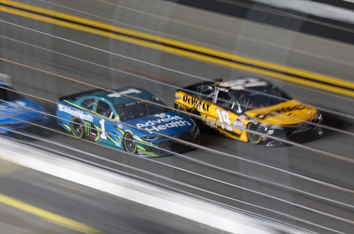Martin Truex Jr. , driver of the No. 19 Toyota, and Kurt Busch, driver of the No. 1 Chevrolet, race side-by-side during the Busch Clash on Feb. 9, 2021, at Daytona International Speedway. | David Rosenblum/Icon Sportswire via Getty Images