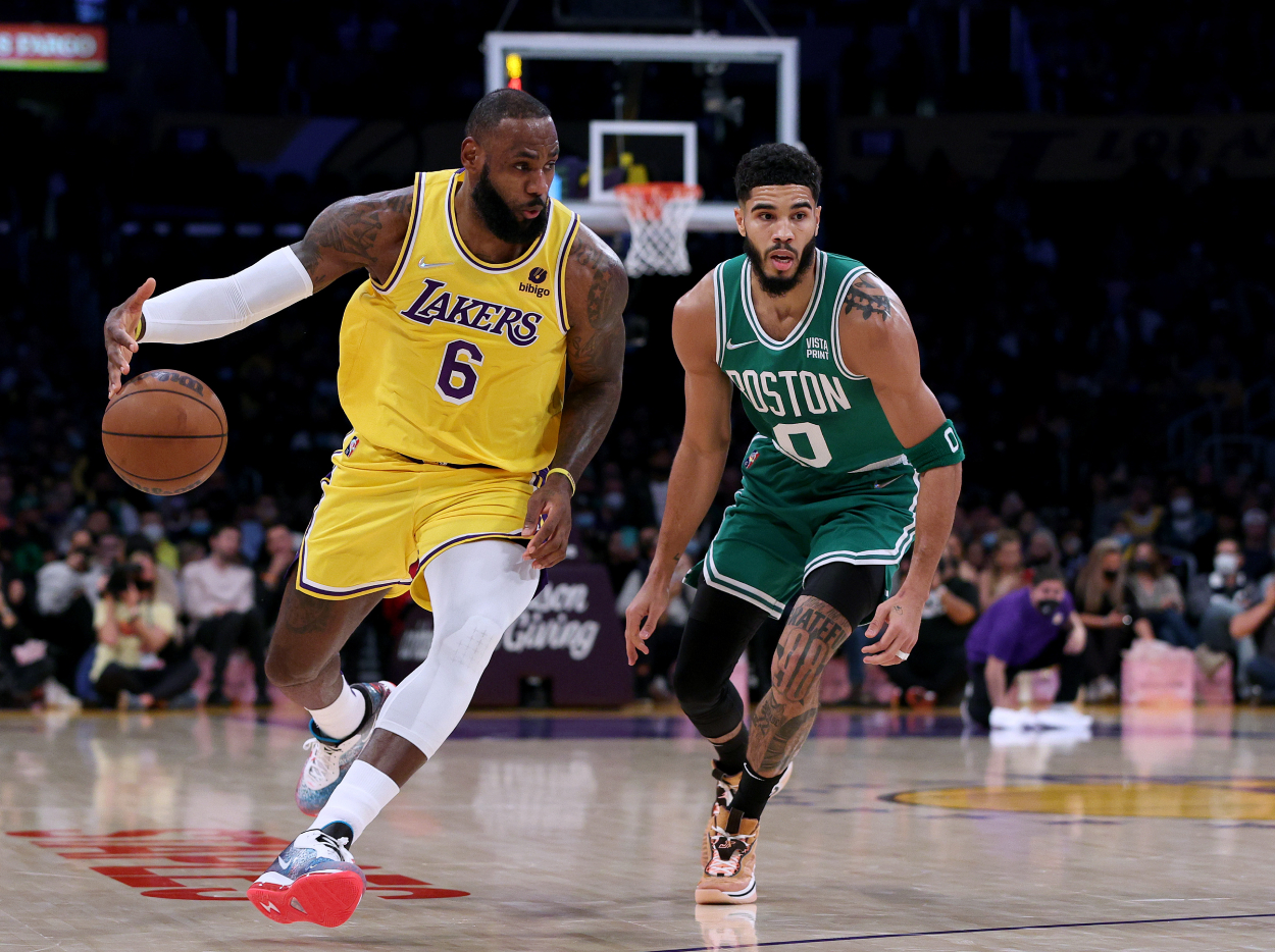 LeBron James #6 of the Los Angeles Lakers dribbles past Jayson Tatum #0 of the Boston Celtics.