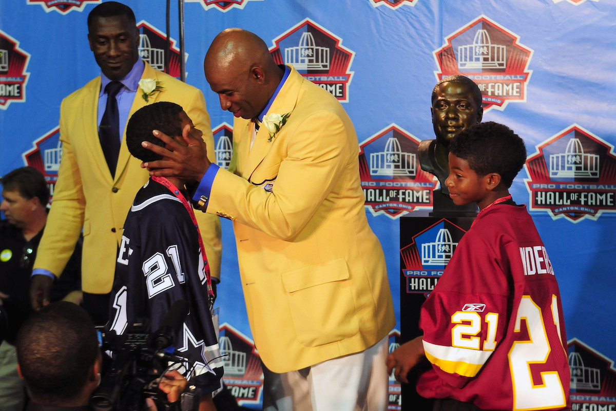 Cornerback Deion Sanders talks to his son Deion Sanders Jr. at the 2011 Enshrinement Ceremony for the Pro Football Hall of Fame