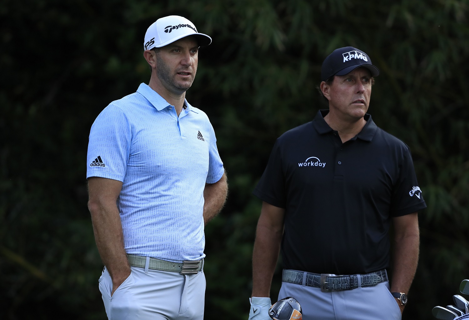 Phil Mickelson of the United States waits with Dustin Johnson of the United States during The Players Championship on The Stadium Course at TPC Sawgrass on March 12, 2020. | Cliff Hawkins/Getty Images