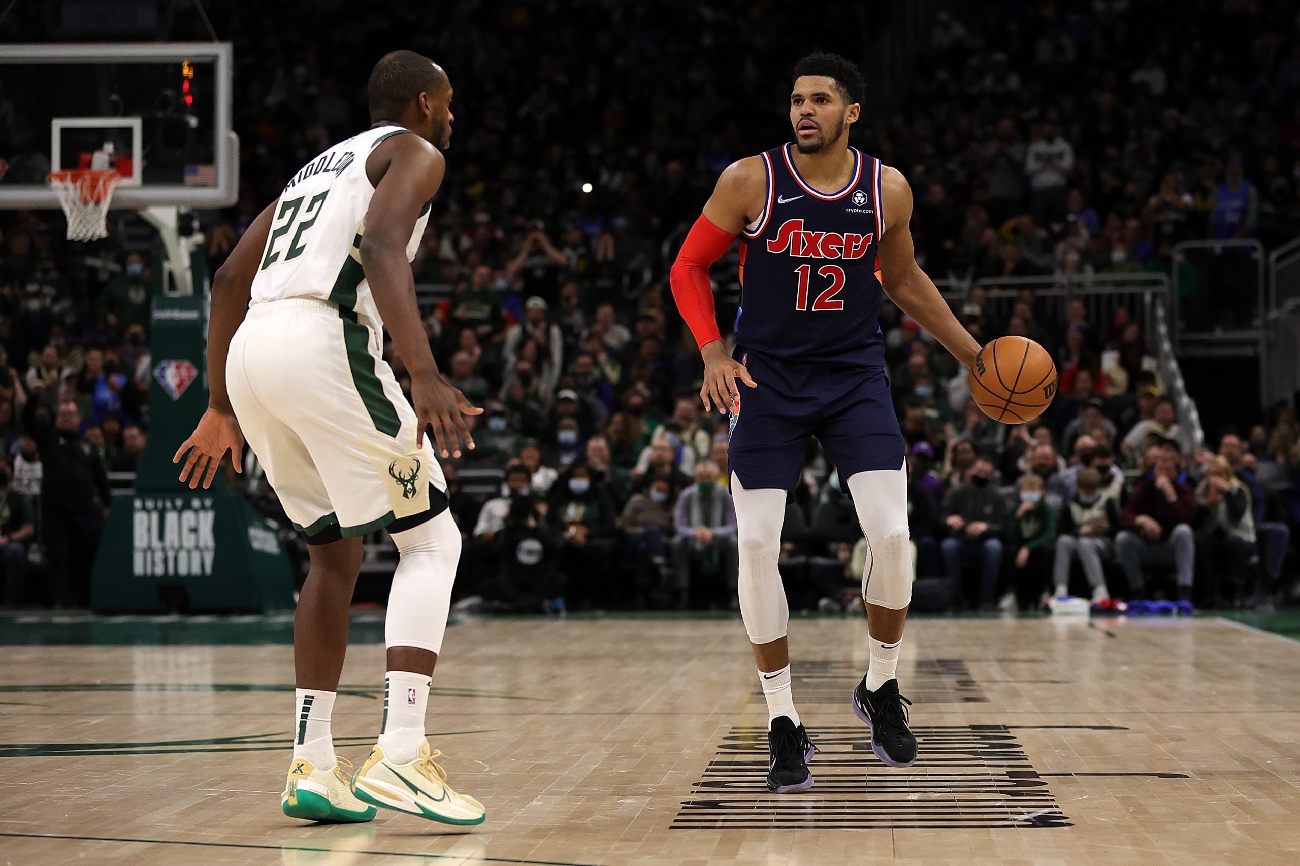 Tobias Harris of the Sixers dribbles against Khris Middleton of the Bucks