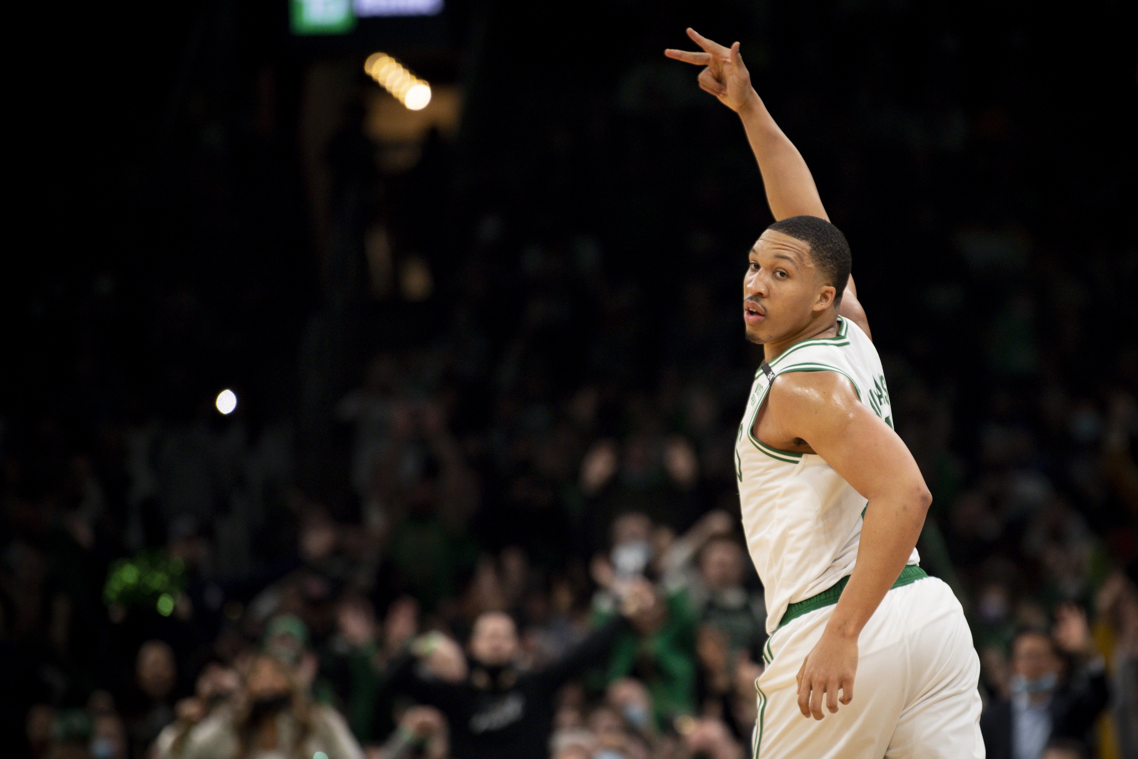 Boston Celtics forward Grant Williams celebrates a three-pointer during an NBA game against the Detroit Pistons in February 2022