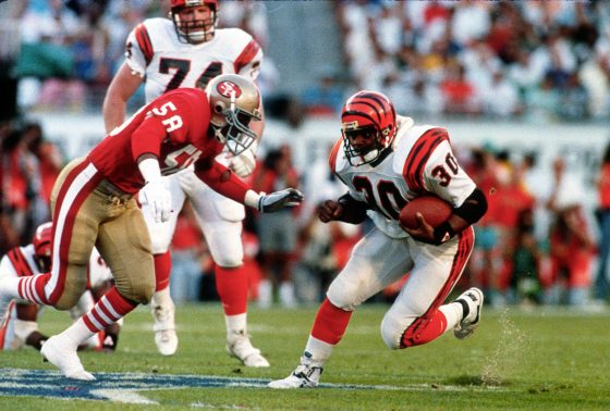 Ickey Woods of the Cincinnati Bengals carries the ball while being pursued by Keena Turner of the San Francisco 49ers during Super Bowl 23.