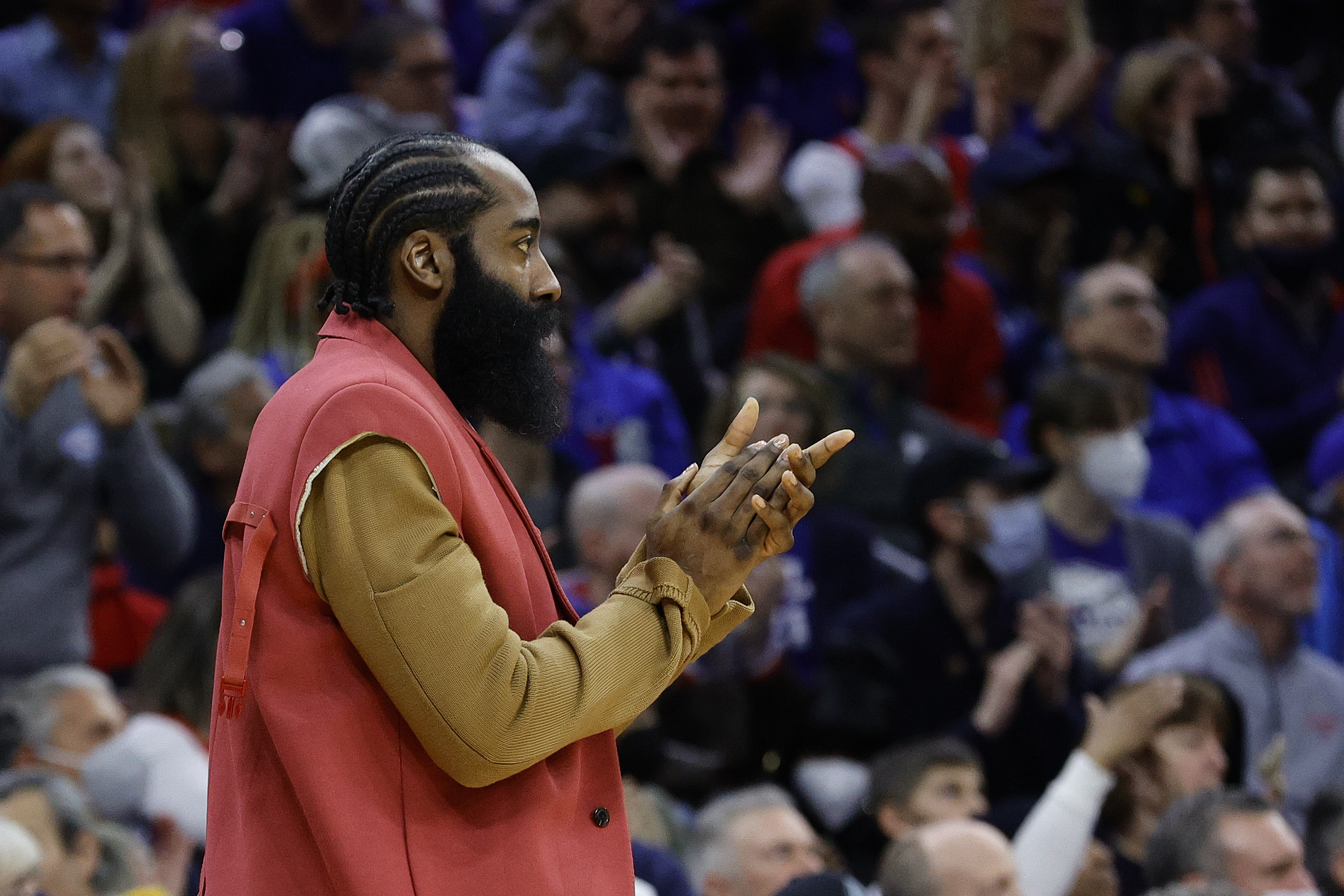 James Harden watches a game between the Philadelphia 76ers and Boston Celtics