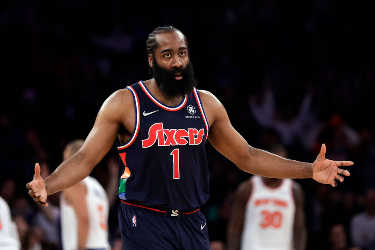 Philadelphia 76ers guard James Harden gestures on the court.