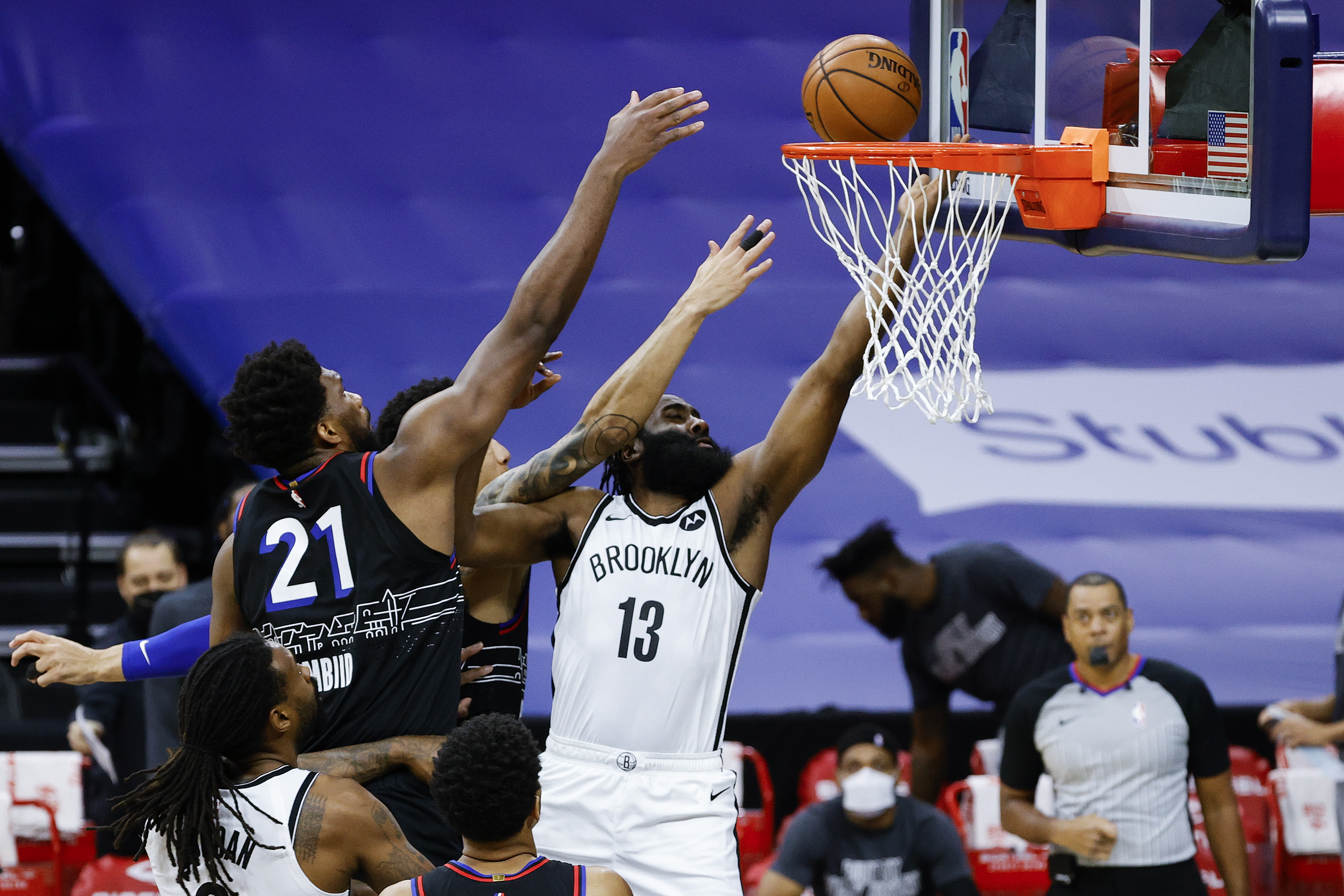 James Harden goes up for a layup against Philadelphia 76ers center Joel Embiid during an NBA game in February 2021