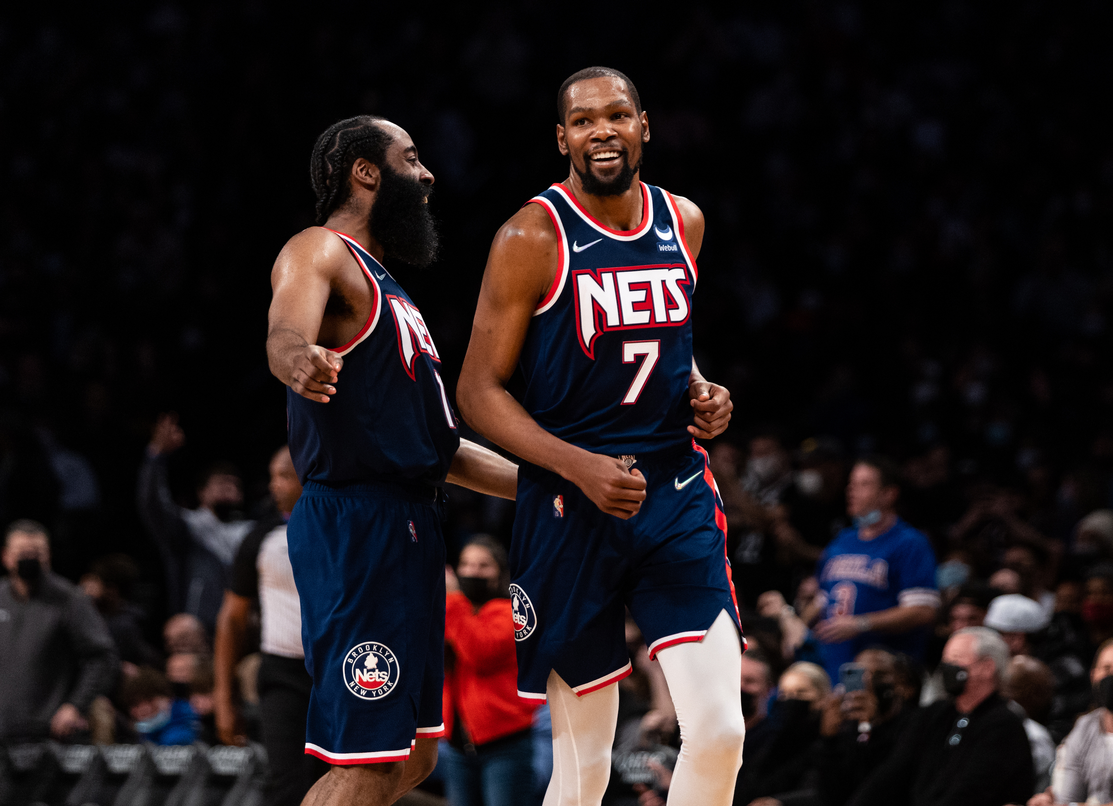Brooklyn Nets stars James Harden (L) and Kevin Durant celebrate during an NBA game against the Philadelphia 76ers in December 2021