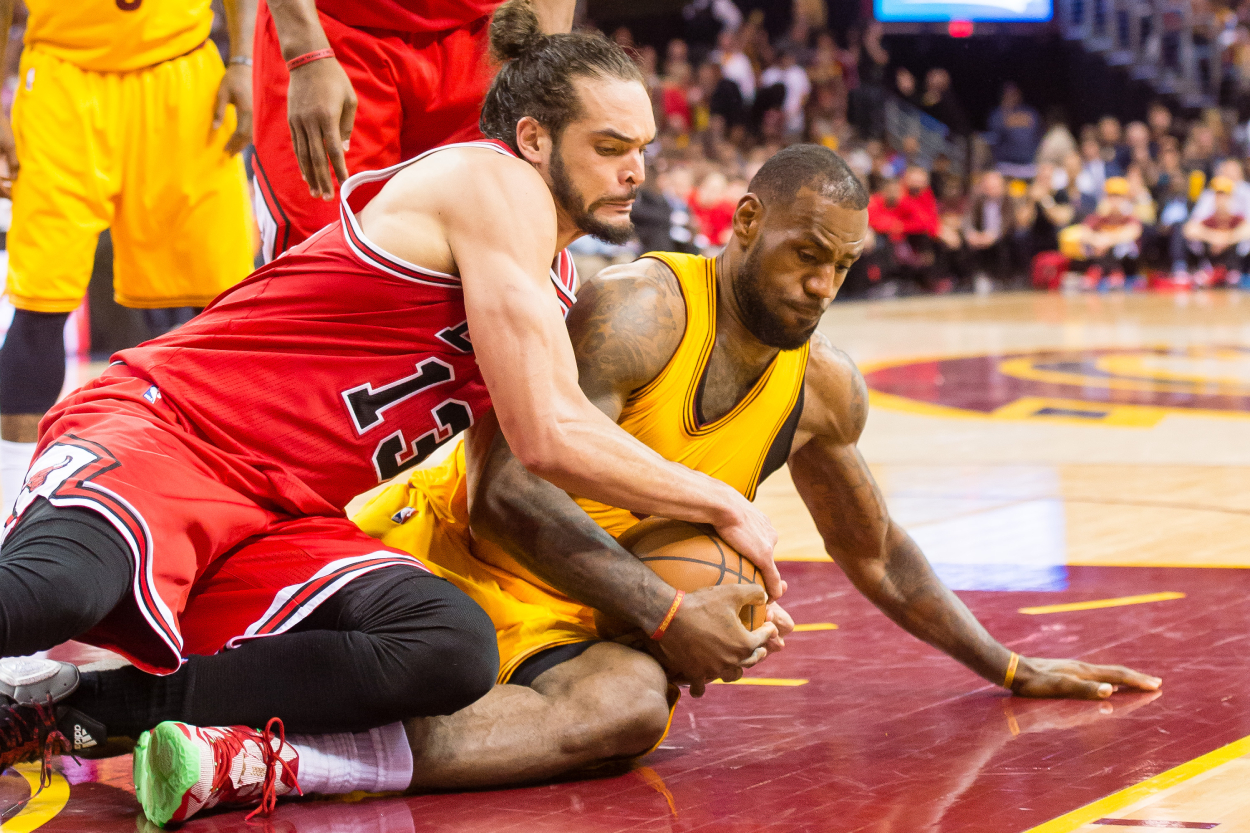 Joakim Noah of the Chicago Bulls and LeBron James of the Cleveland Cavaliers fight for a loose ball.