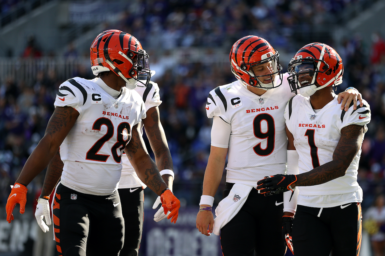Joe Mixon and Joe Burrow celebrate with wide receiver Ja'Marr Chase of the Cincinnati Bengals after Chase scored a second half touchdown against the Baltimore Ravens at M&T Bank Stadium on October 24, 2021 in Baltimore, Maryland.