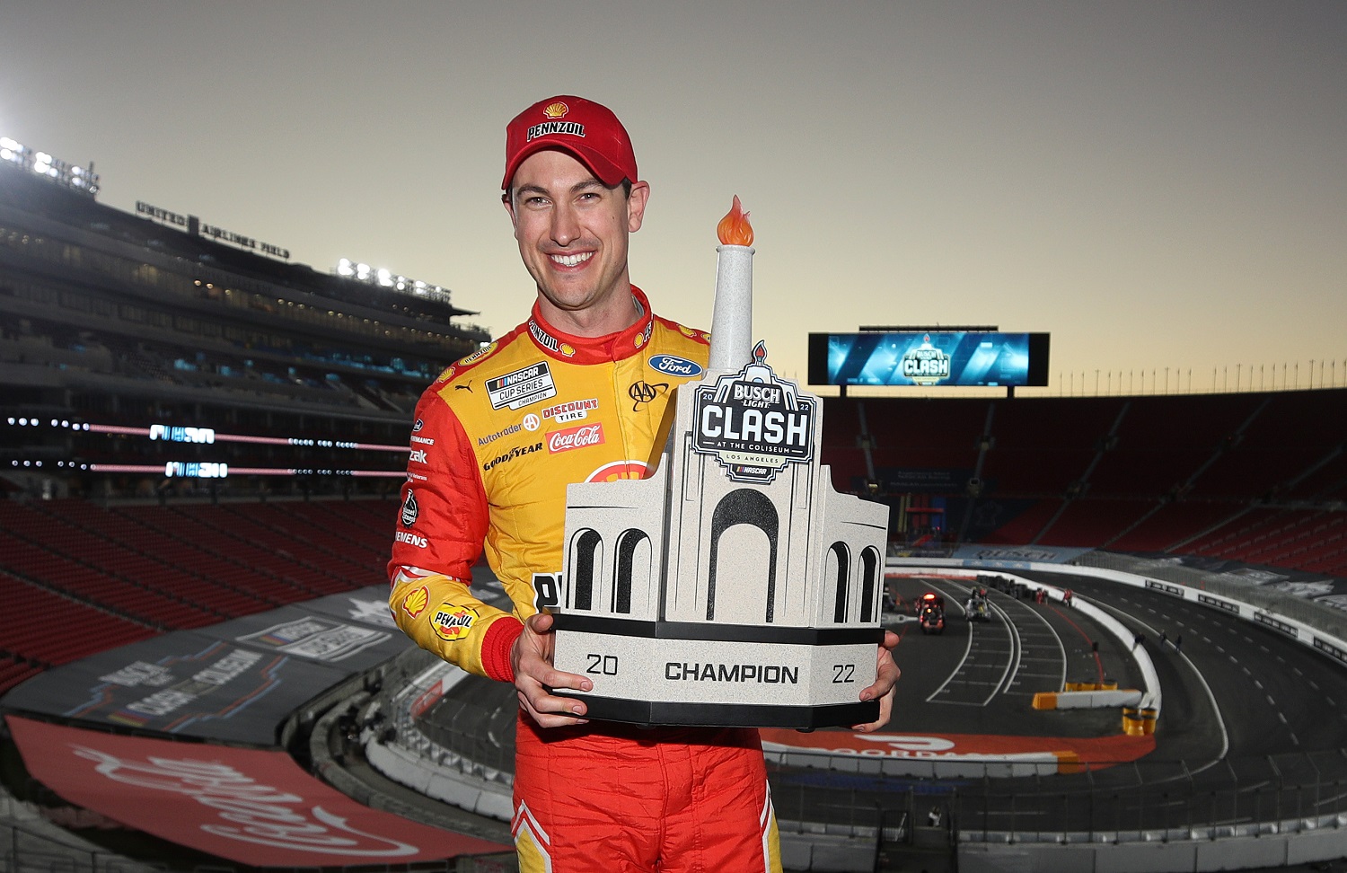 Joey Logano poses with the trophy after winning the NASCAR Cup Series Busch Light Clash at the Los Angeles Memorial Coliseum on Feb. 6, 2022. | Meg Oliphant/Getty Images