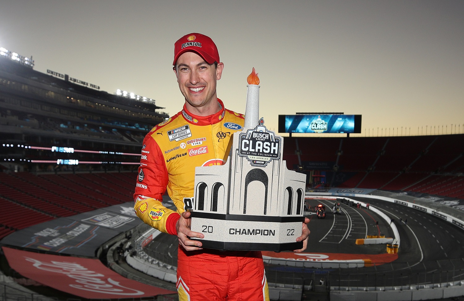 Joey Logano poses with the trophy after winning the NASCAR Cup Series Busch Light Clash at the Los Angeles Memorial Coliseum on Feb. 6, 2022. | Meg Oliphant/Getty Images