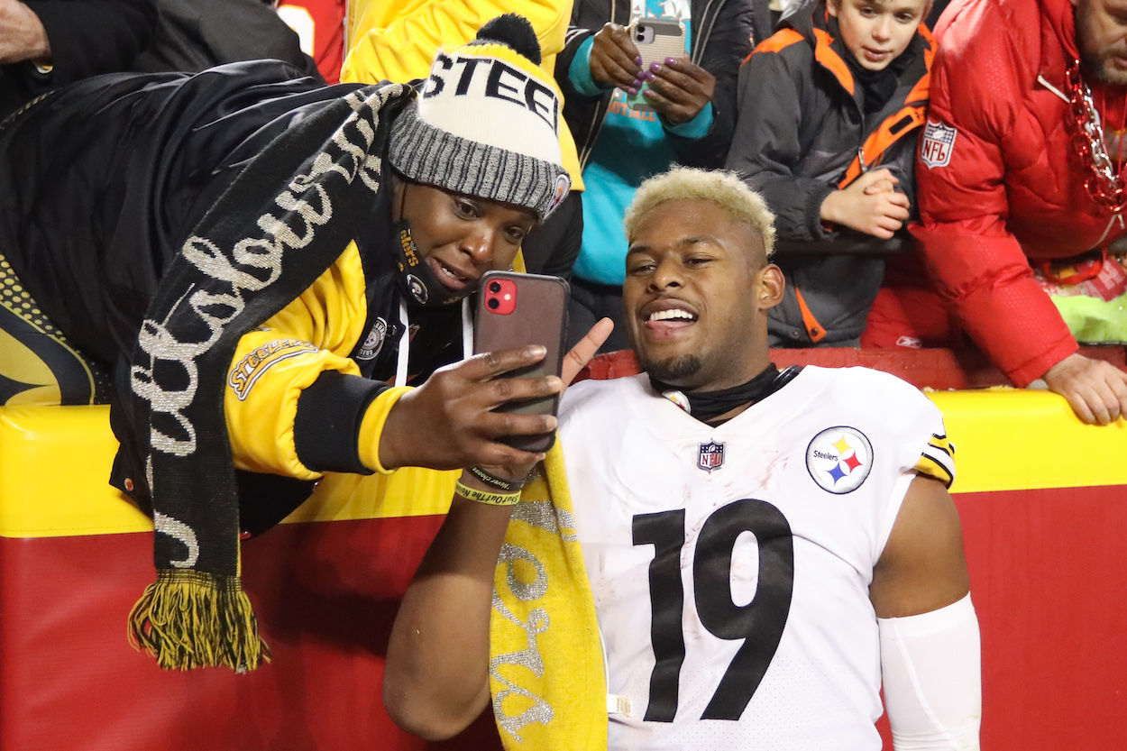 Pittsburgh Steelers wide receiver JuJu Smith-Schuster takes a selfie with a fan after an AFC wild card playoff game between the Pittsburgh Steelers and Kansas City Chiefs on Jan 16, 2022 at GEHA Field at Arrowhead Stadium in Kansas City, MO.