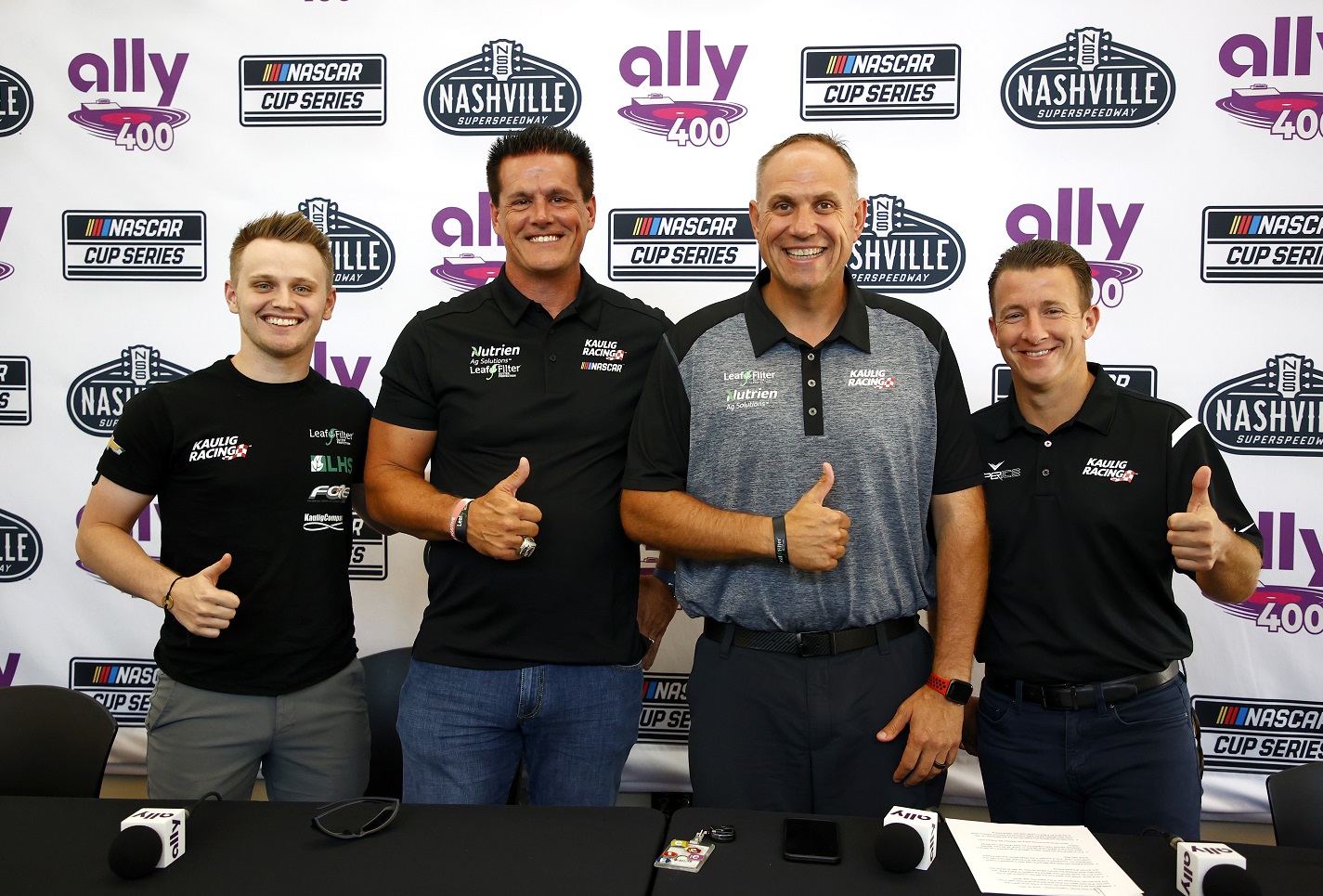 Justin Haley, team owner Matt Kaulig, Kaulig Racing president Chris Rice, and AJ Allmendinger pose for photos after the announcement that Kaulig Racing will race full-time in the NASCAR Cup Series.