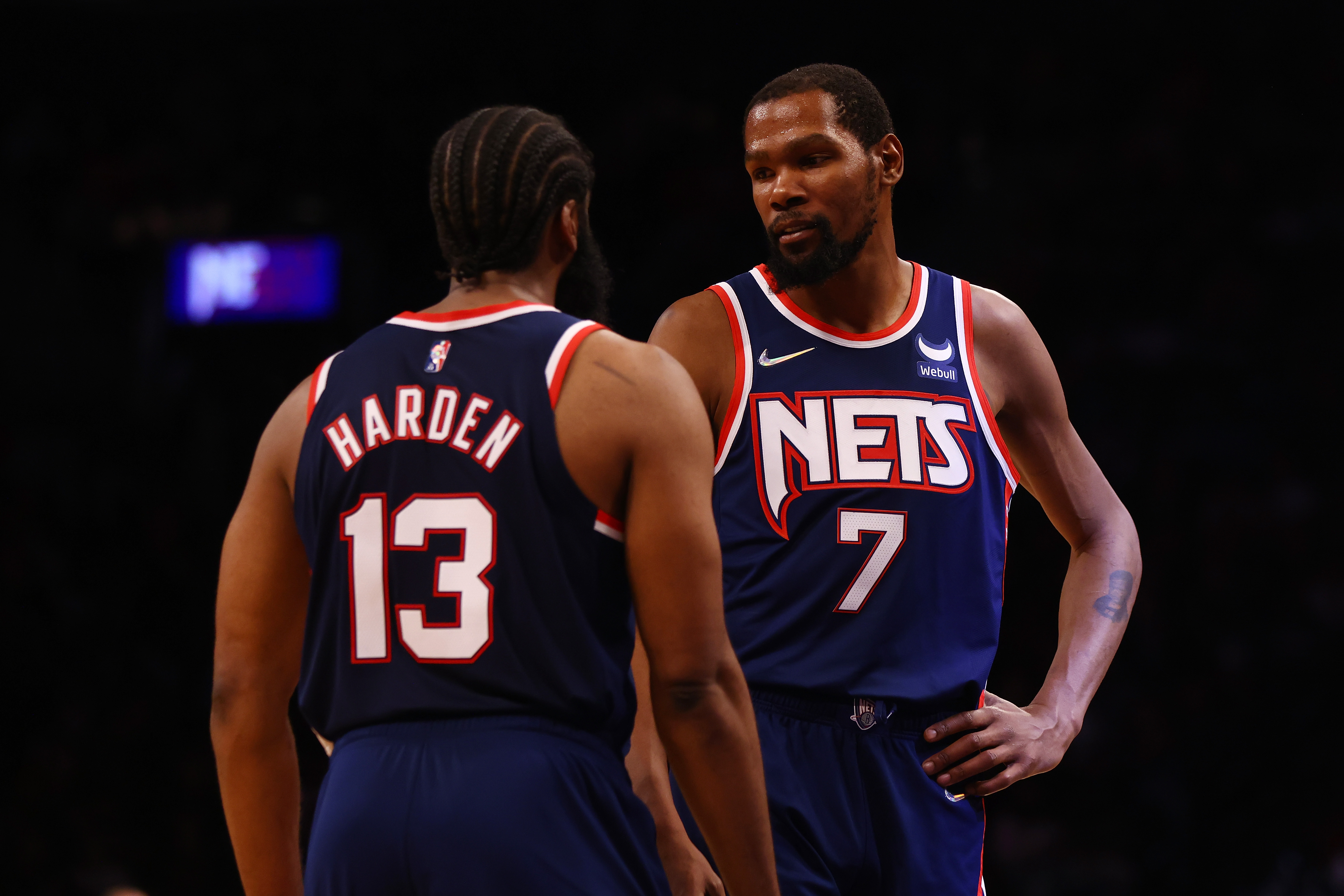 Brooklyn Nets star Kevin Durant (7) talks with James Harden during a game in December