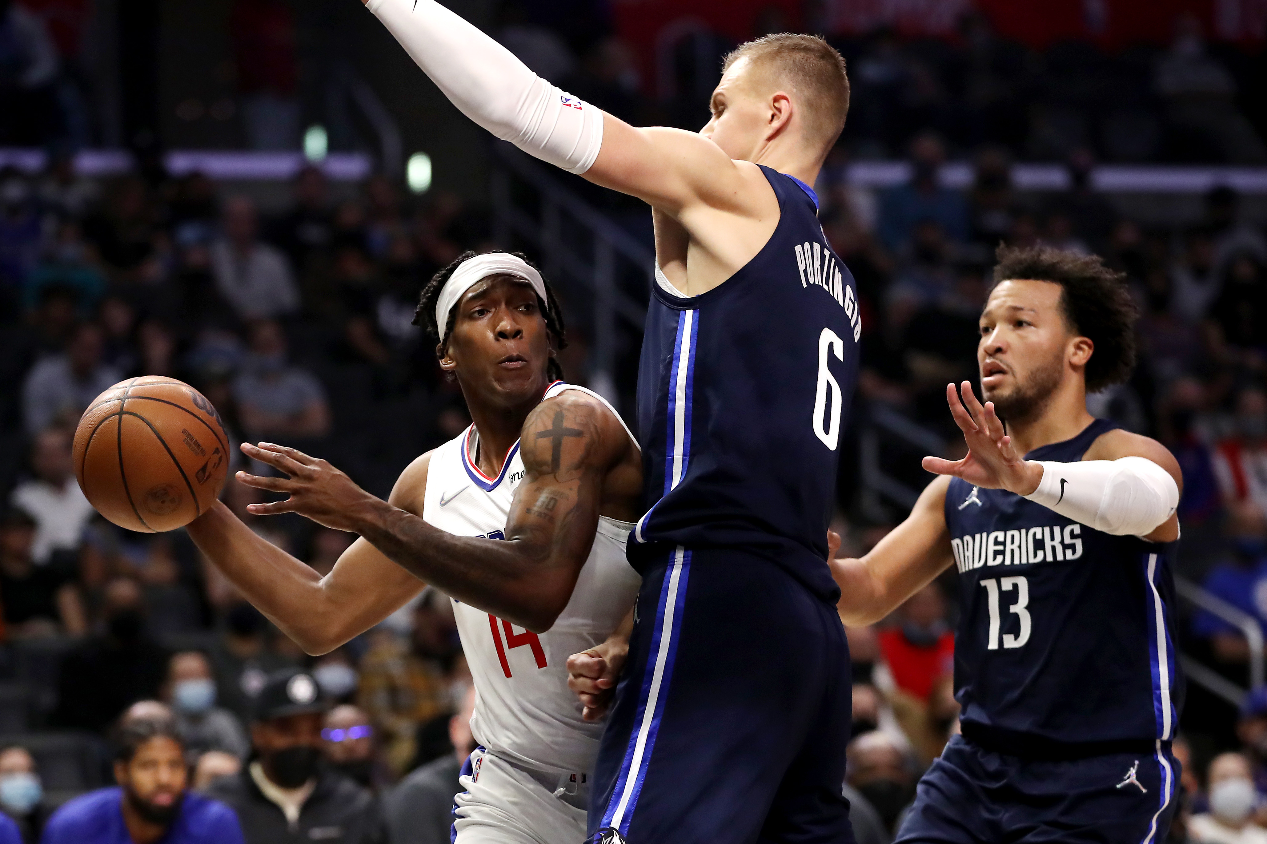 Former Dallas Mavericks big man Krisaps Porzingis (6) defends Los Angeles Clippers wing Terance Mann during an NBA game in November 2021