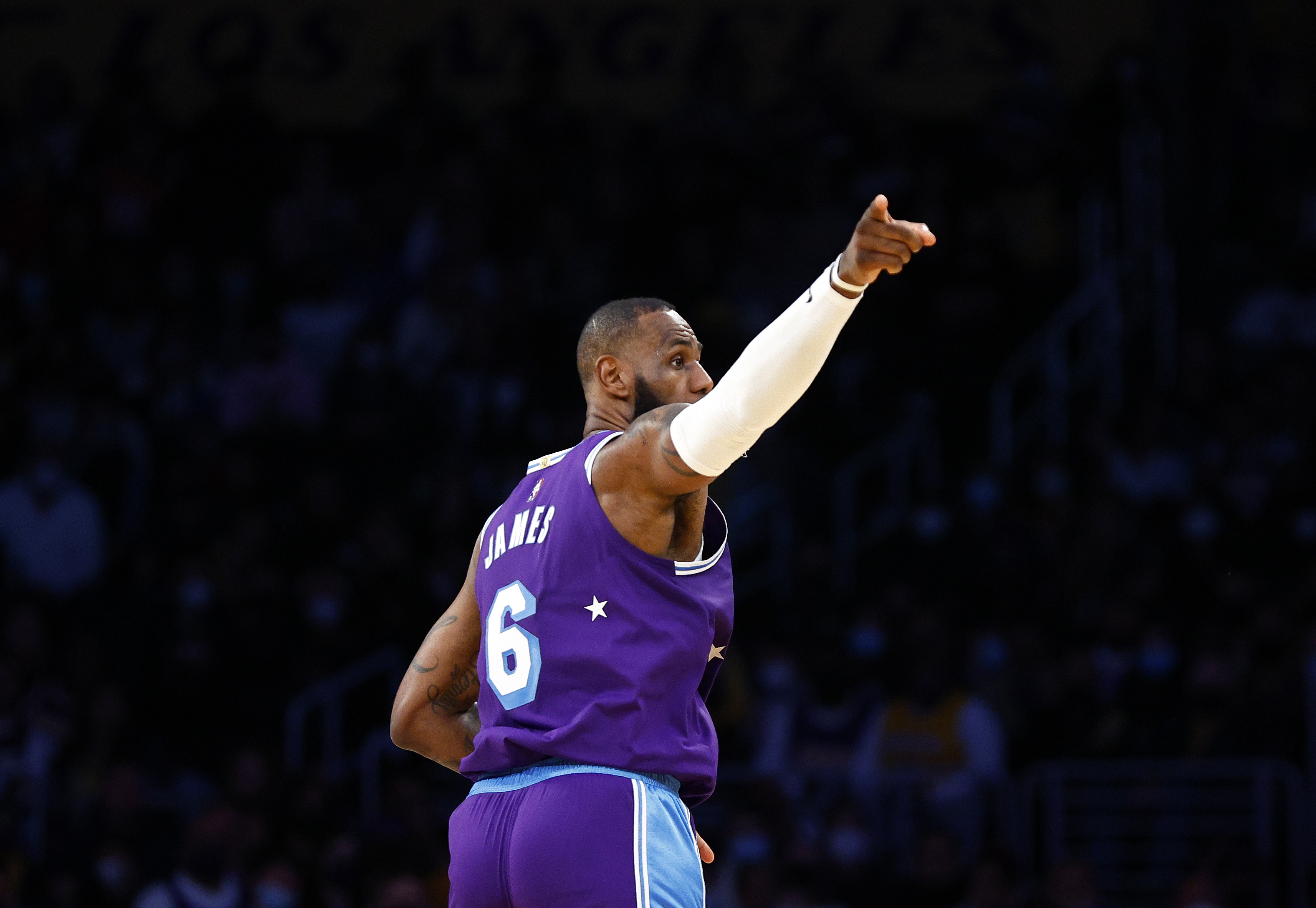 LeBron James points during an NBA game between the Los Angeles Lakers and New York Knicks in February 2022