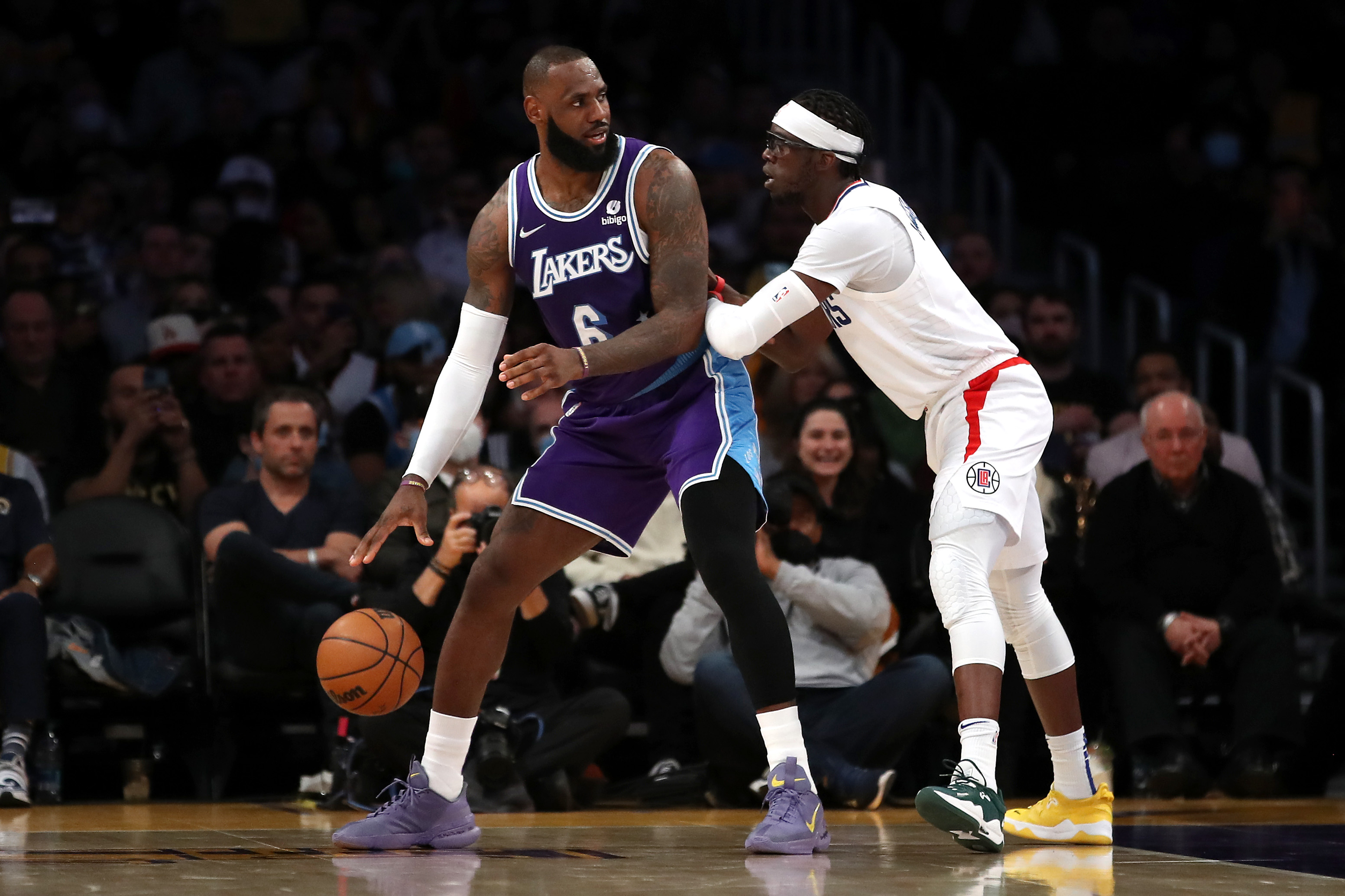 Los Angeles Lakers forward LeBron James backs down LA Clippers guard Reggie Jackson during a game in February 2022