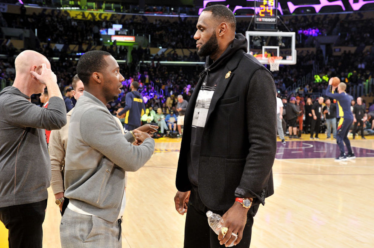 Agent Rich Paul and NBA Star LeBron James talk at a Los Angeles Lakers game.