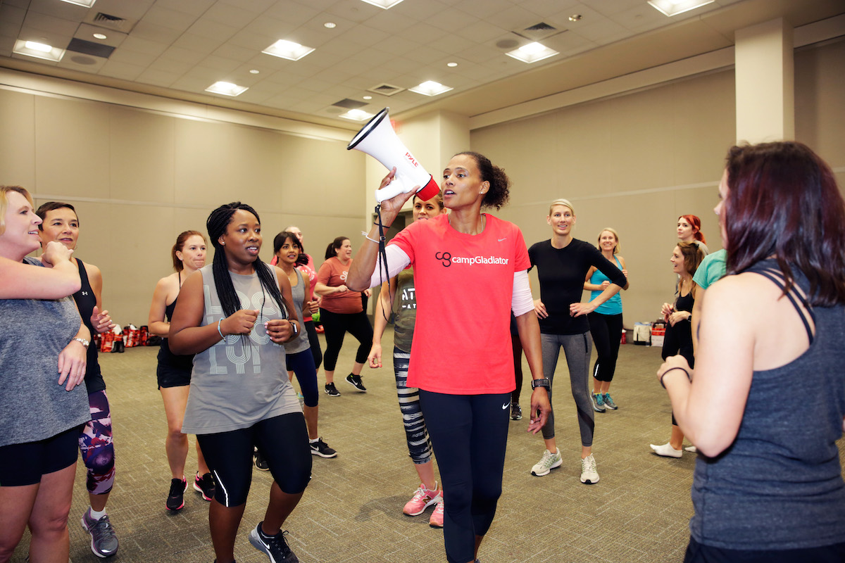 Marion Jones speaks into a bullhorn during a Camp Gladiator Workout at the 2017 Texas Conference For Women