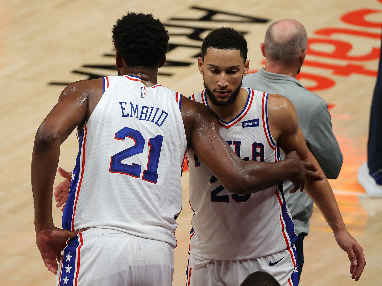 Philadelphia 76ers stars Joel Embiid (left) and Ben Simmons (right) hug after being taken out of the game in the final minutes of their win over the Atlanta Hawks on June 11, 2021 in Atlanta, Georgia.