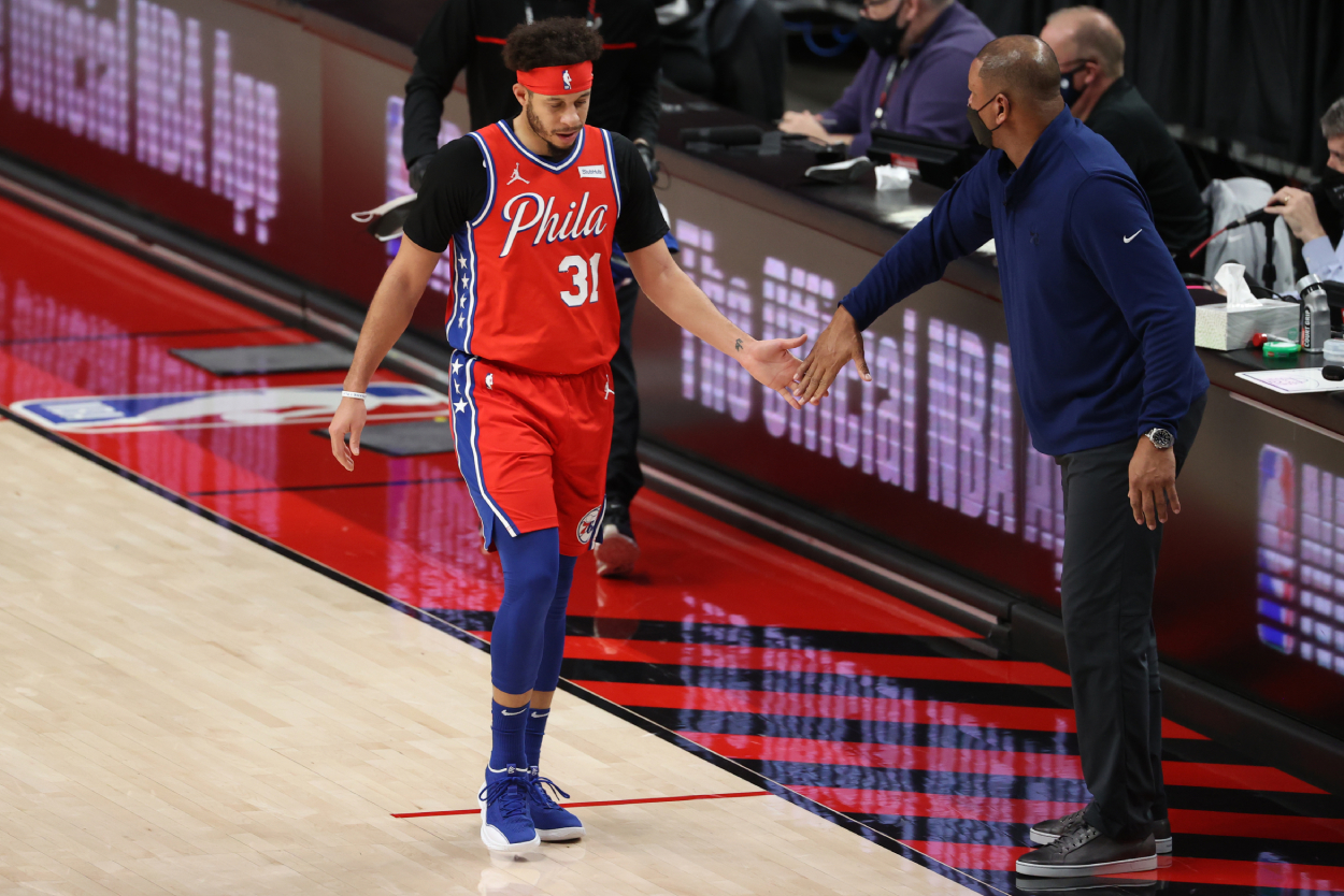 Guard Seth Curry, who was traded from the Philadelphia 76ers to the Brooklyn Nets on Thursday, is congratulated by head coach and father-in-law Doc Rivers against the Portland Trail Blazers at Moda Center on February 11, 2021.