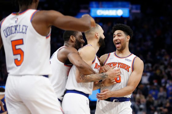 Quentin Grimes celebrates with New York Knicks teammates after a win over the Golden State Warriors in February 2022