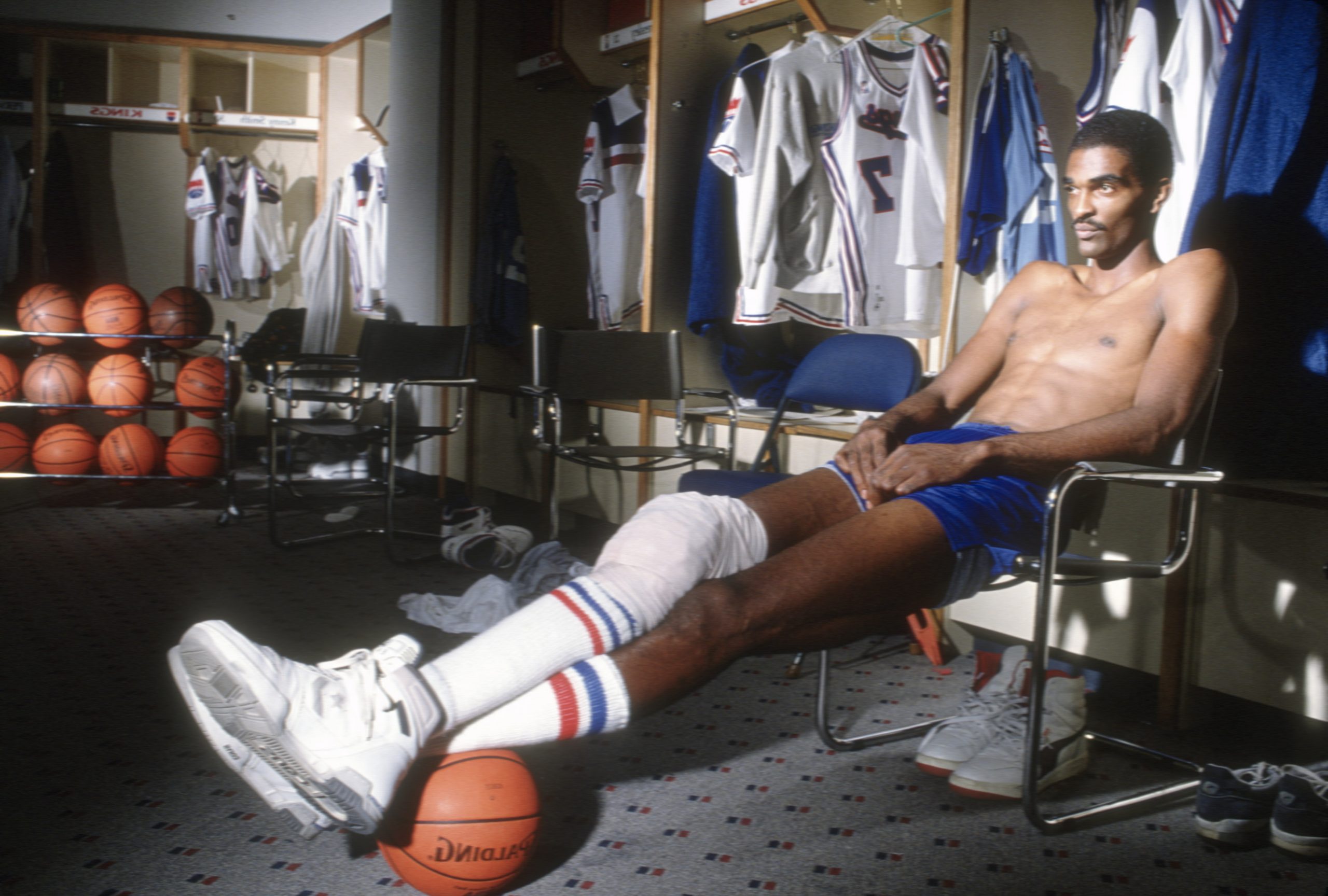 Ralph Sampson of the Sacramento Kings sits in the locker room prior to the start of an NBA basketball game circa 1989.