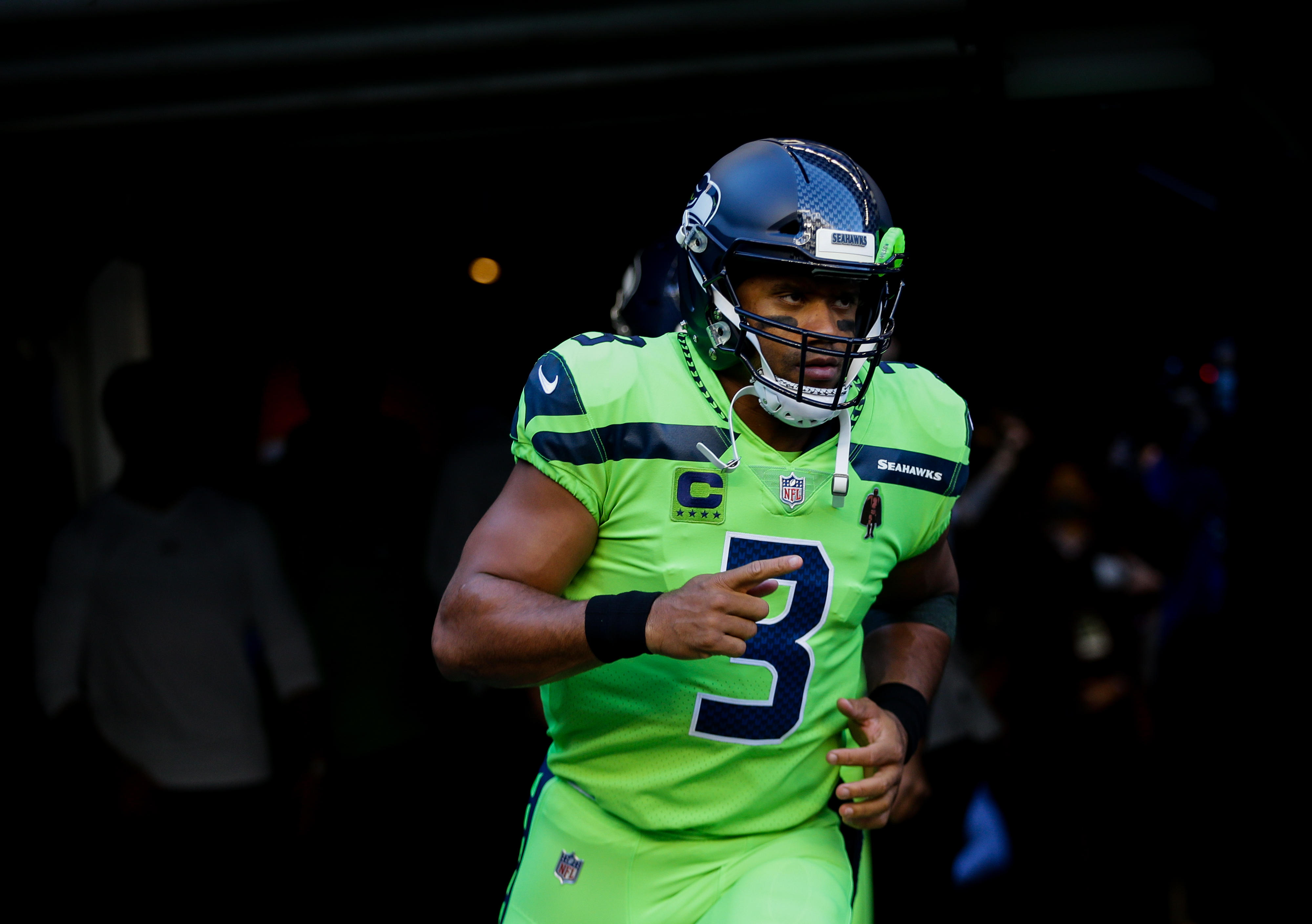 Quarterback Russell Wilson of the Seattle Seahawks runs out for the game against the Los Angeles Rams at Lumen Field on October 7, 2021 in Seattle, Washington. The Russell Wilson contract makes it much easier to trade the QB this offseason.
