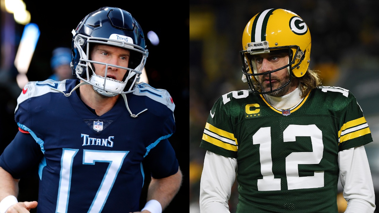 Titans QB Ryan Tannehill runs out of the tunnel before a game; Packers QB Aaron Rodgers looks on during a game