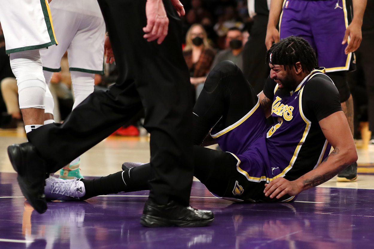 Los Angeles Lakers forward Anthony Davis hold his ankle in pain.