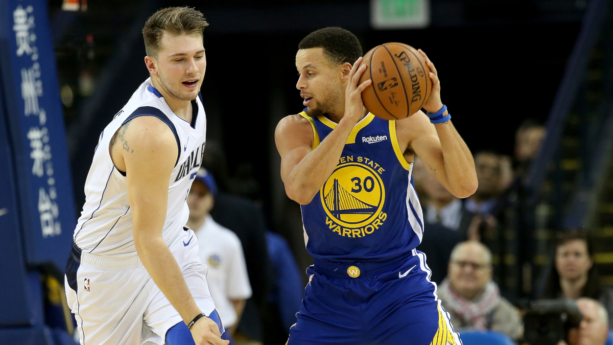 Luka Dončić of the Dallas Mavericks defends Stephen Curry of the Golden State Warriors.