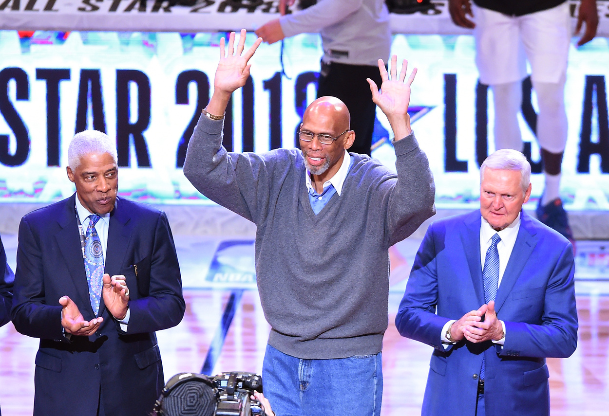 NBA Hall of Famers Julius Erving, Kareem Abdul-Jabbar, and Jerry acknowledge the crowd.