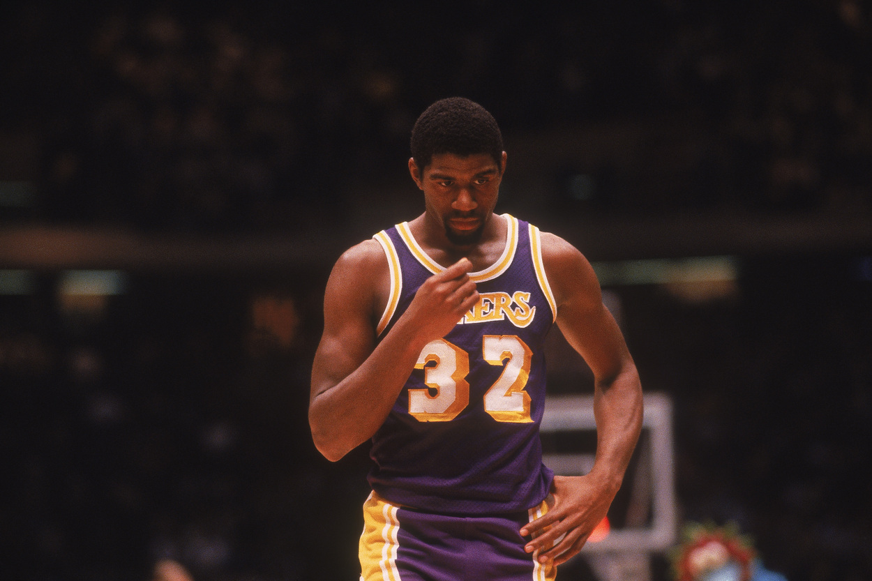 Los Angeles Lakers legend Magic Johnson looks down.