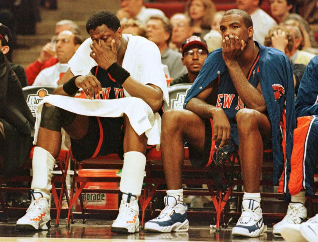 New York Knicks big men Patrick Ewing and Charles Oakley sitting on the bench.