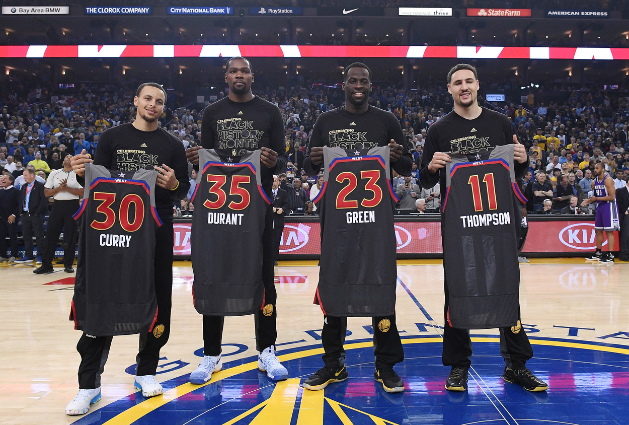 Golden State Warriors All-Stars Klay Thompson, Draymond Green, Kevin Durant, and Stephen Curry pose for a photo.