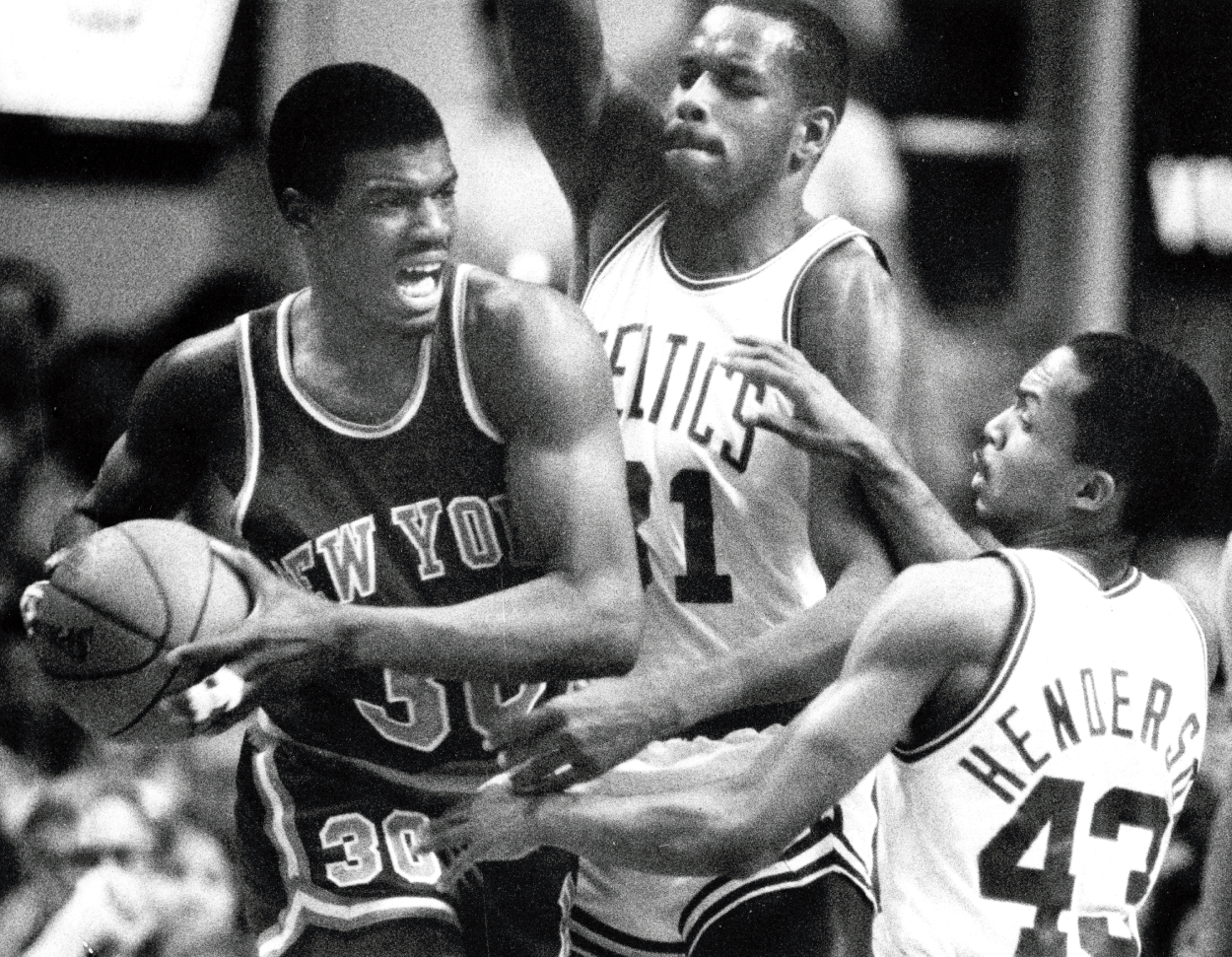 New York Knicks' Bernard King is guarded by the Celtics' Cedric Maxwell, center, and Gerald Henderson, right.