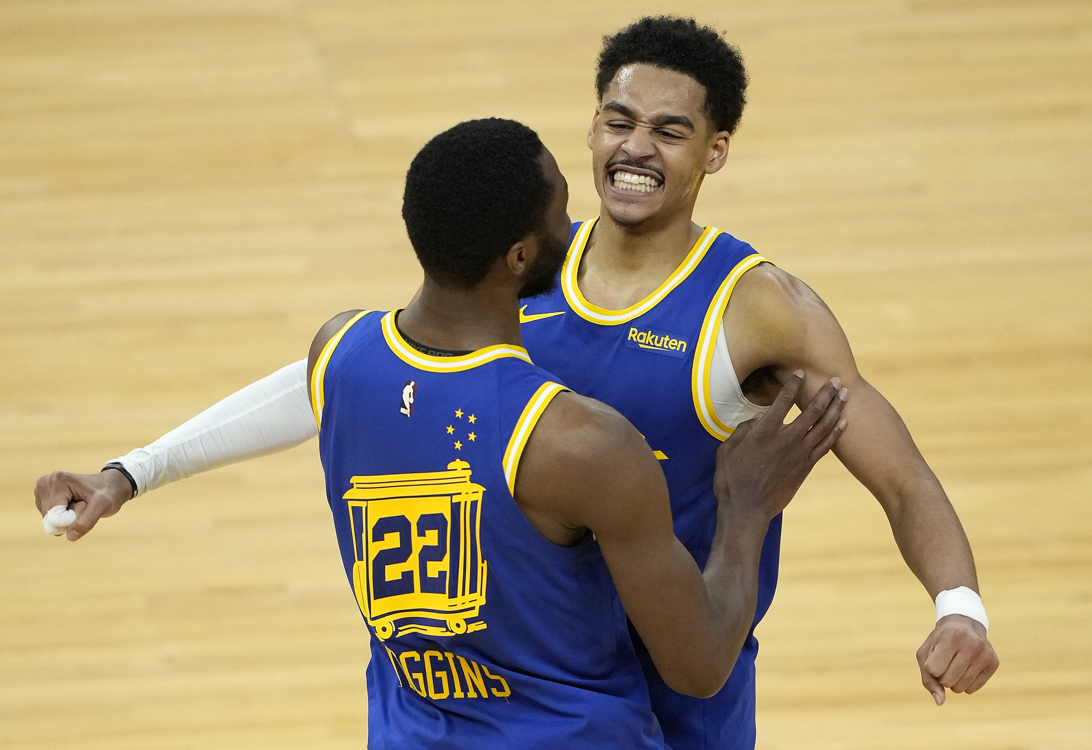 Golden State Warriors wings Andrew Wiggins (22) and Jordan Poole (3) celebrate during an NBA game in May 2021
