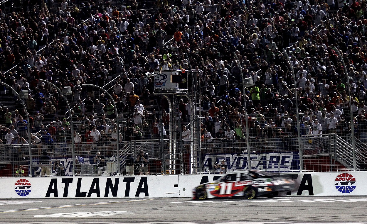 Denny Hamlin crosses the finish line at Atlanta Motor Speedway to win the 2012 NASCAR Cup Series Advocare 500