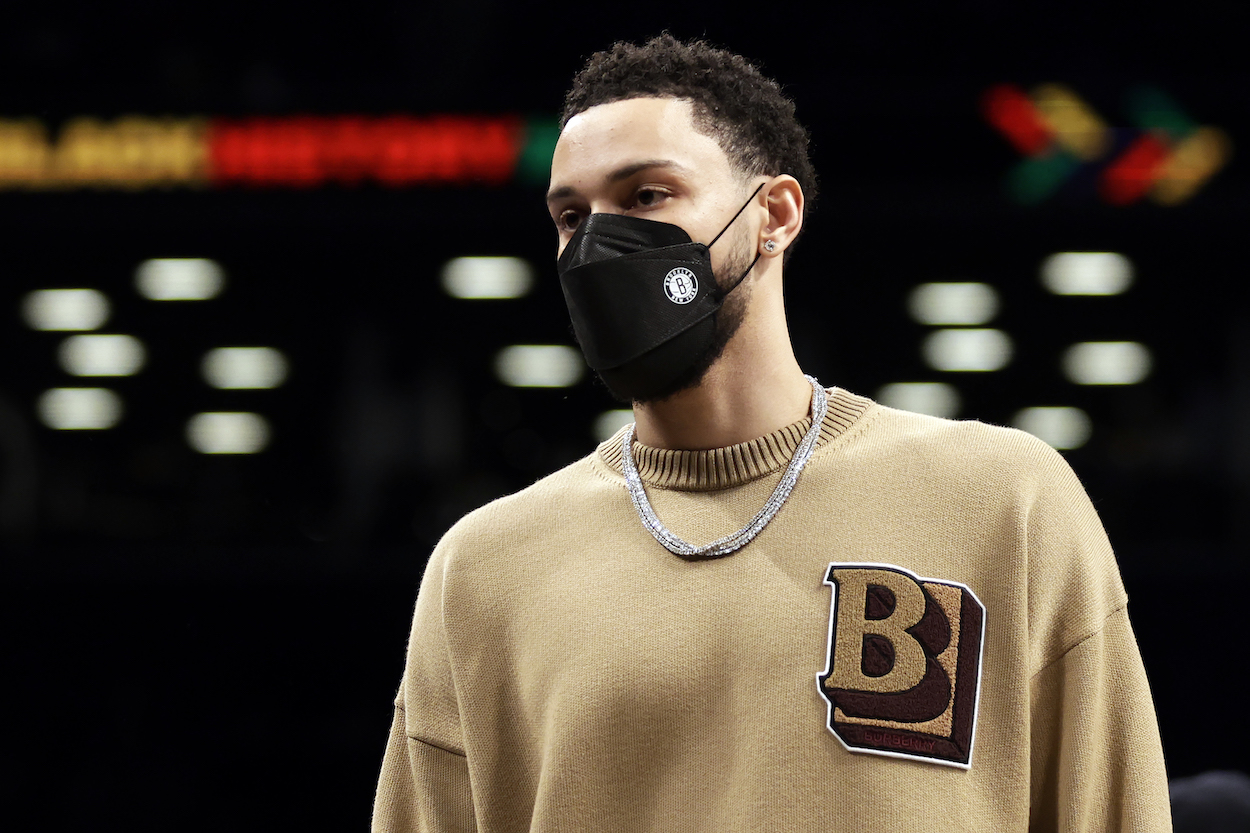 Ben Simmons looks on from the sidelines.