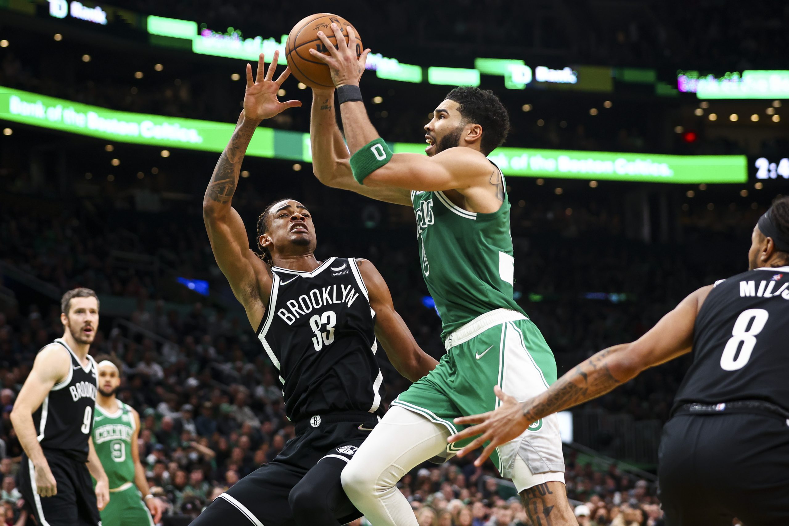 Jayson Tatum of the Boston Celtics drives to the basket past Nic Claxton of the Brooklyn Nets.