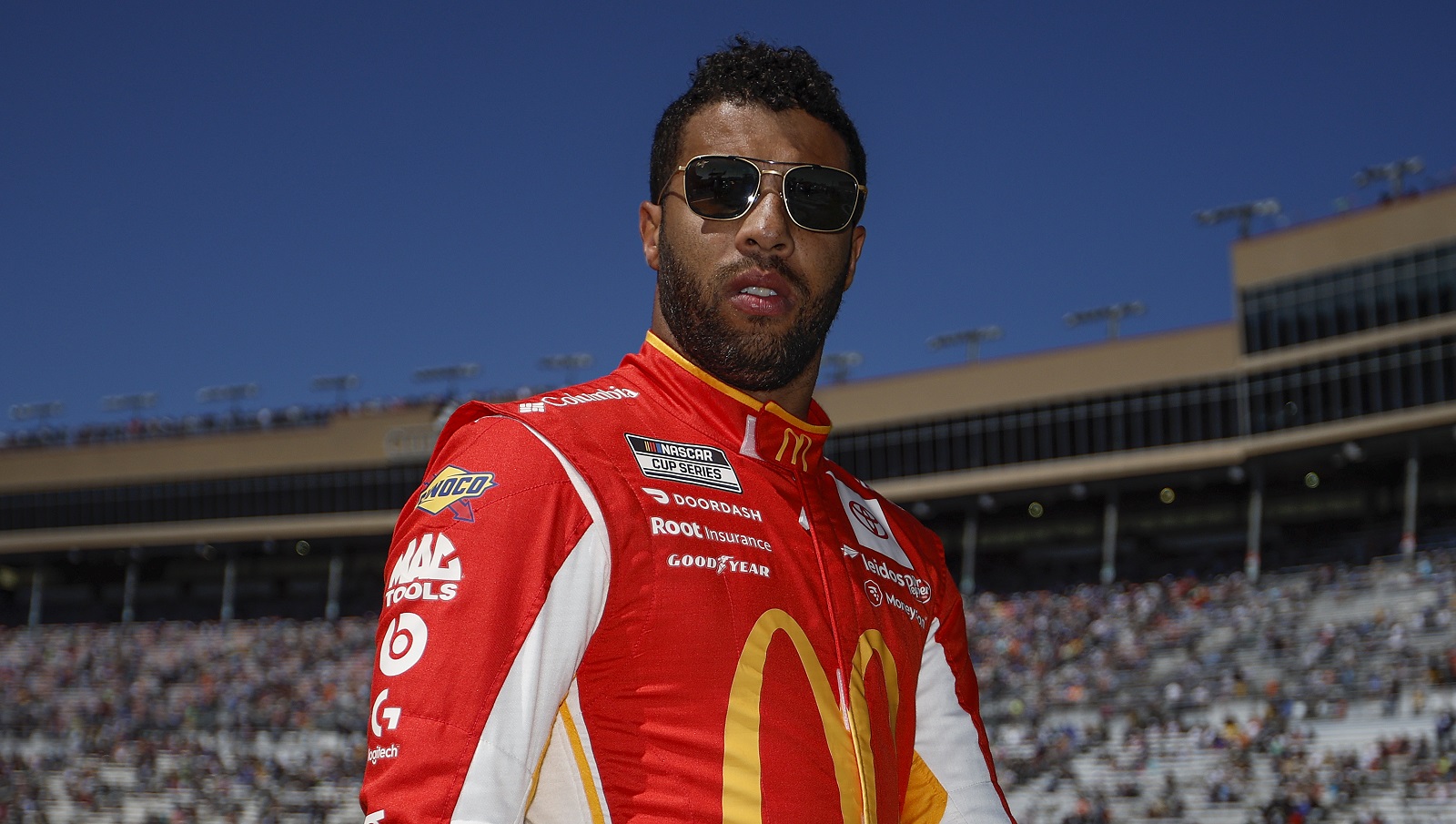 Bubba Wallace, driver of the No. 23 Toyota, walks through the infield grass prior to the NASCAR Cup Series Folds of Honor QuikTrip 500 at Atlanta Motor Speedway on March 20, 2022.