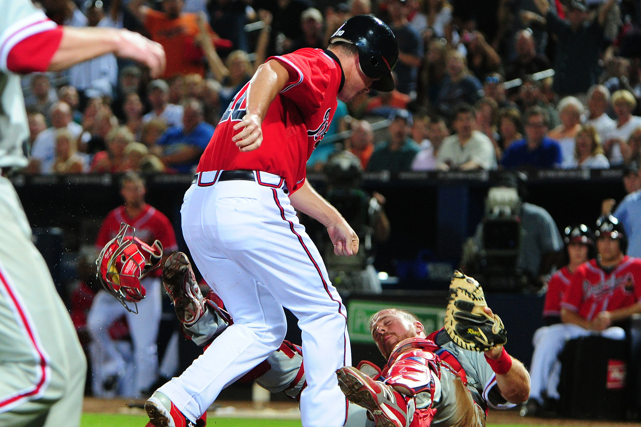 Atlanta Braves third baseman Chipper Jones and Philadelphia Phillies catcher Erik Kratz in 2012.