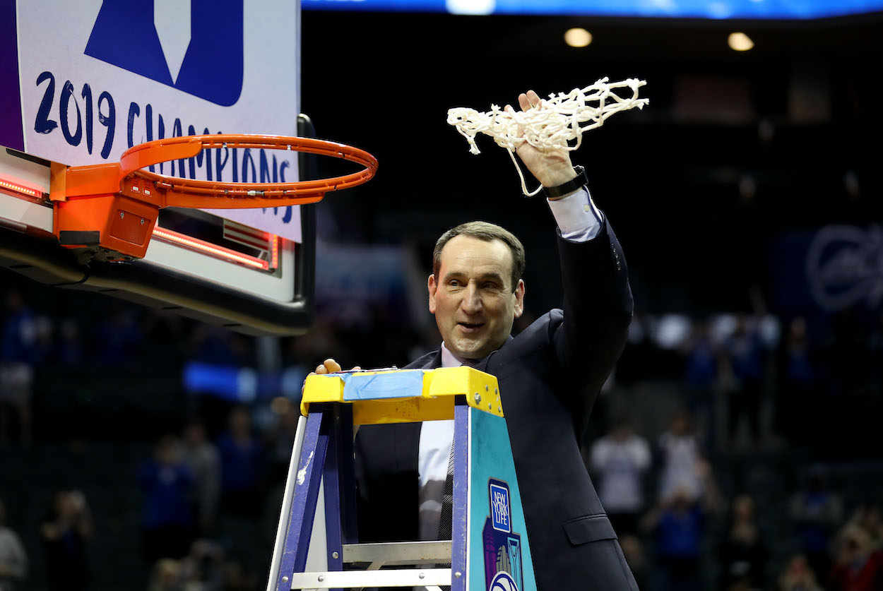 Coach K cuts down the net.