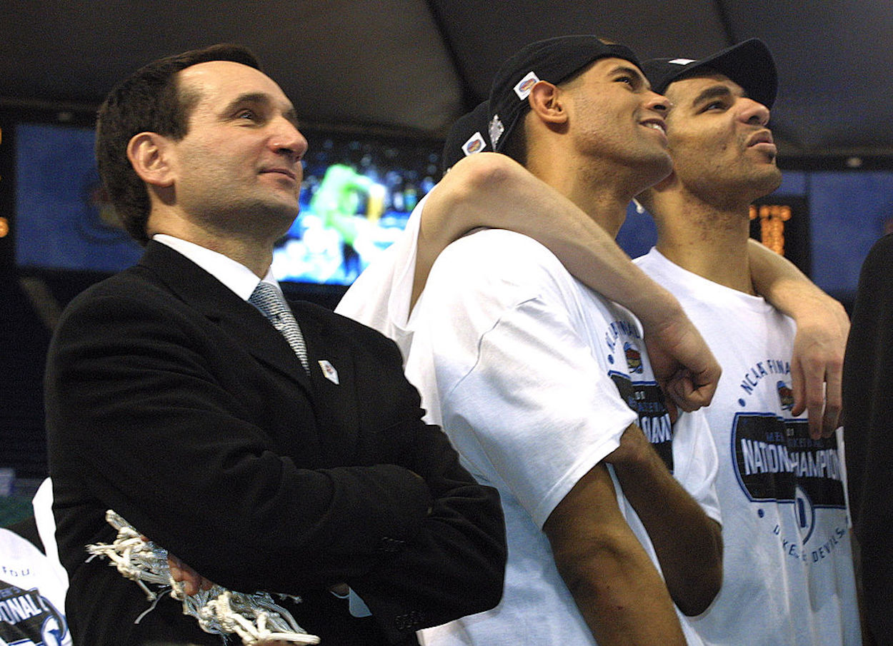 Mike Krzyzewski (L) and Carlos Boozer (R) stand together after winning an NCAA title with Duke.