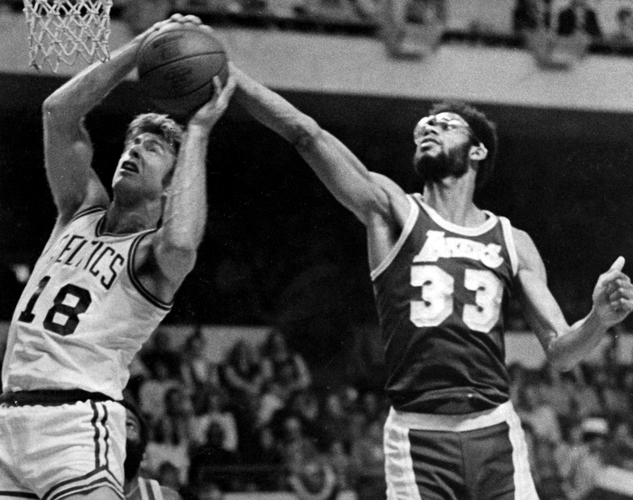 Los Angeles Lakers center Kareem Abdul-Jabbar, right, attempts to block a shot from Boston Celtics Dave Cowens.