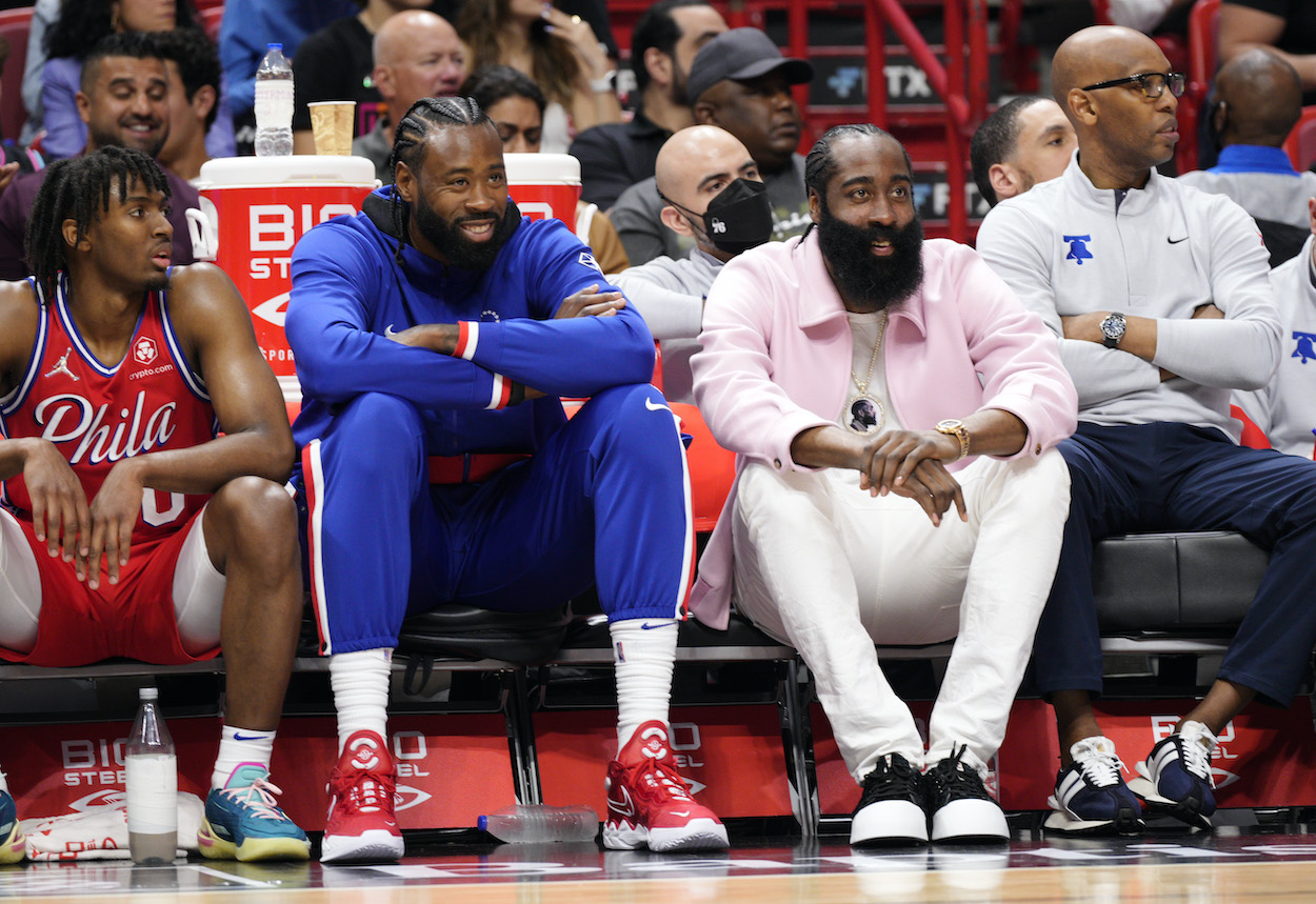 DeAndre Jordan and James Harden watch from the bench.